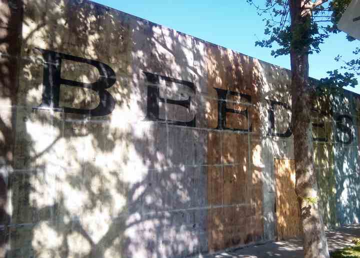 This large, weathered wall features bold, hand-painted lettering which Concord Signs & Banners gave new life by blending artistry and precision to create a unique, impactful appearance.